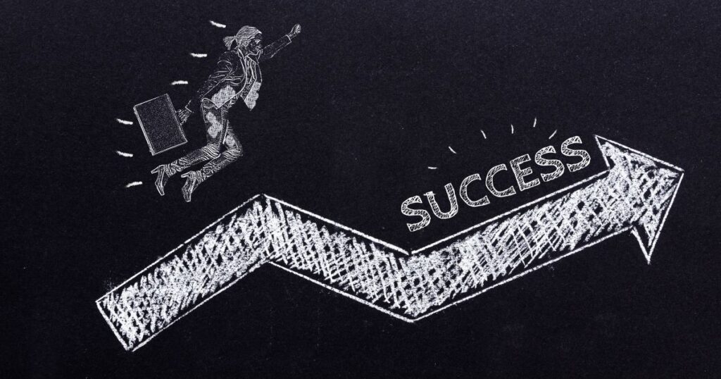 A chalk drawing of a person jumping over a success graph
