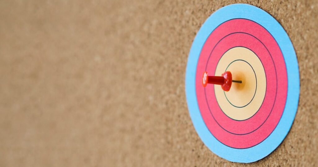 side view colourful target with pin in bullseye