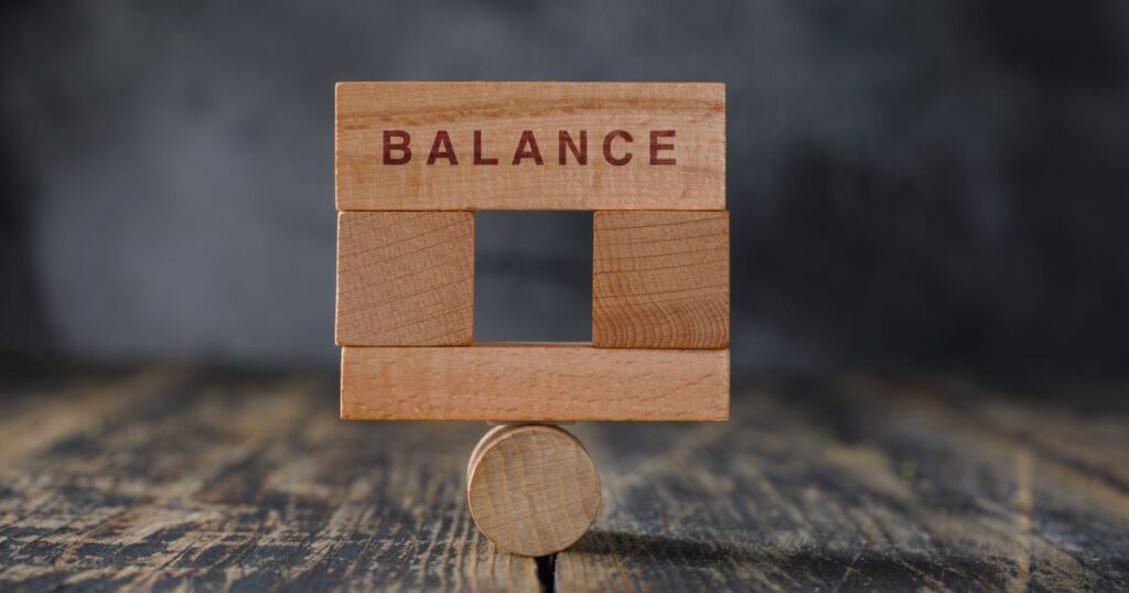 business financial accounting balance concept with wooden blocks side view